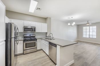 A kitchen with stainless steel appliances and white cabinets